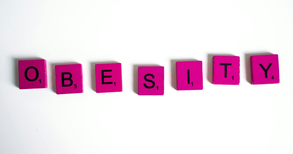 Obesity Spelled on Purple Scrabble Tiles