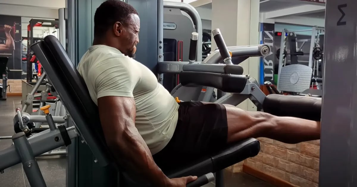 Kenyan bodybuilder Antony Gachau performing leg extensions at the gym