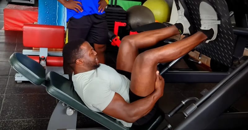 Kenyan bodybuilder Antony Gachau performing heavy leg press exercise