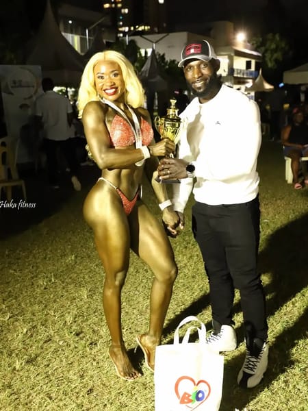 Caren Namenya Mulyanga with her coach after winning Wellness at Mr 001 2025